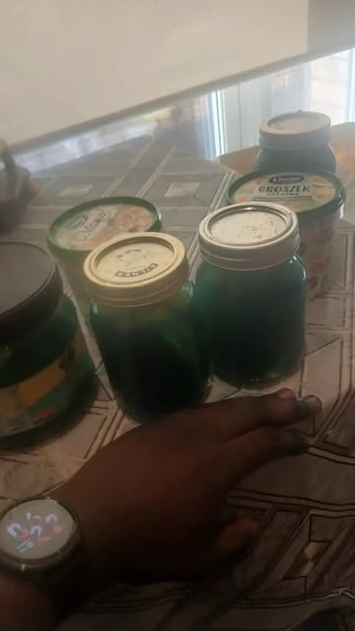 Jars of Kool-Aid pineapple steeping on a kitchen table.